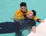 RESCUES, CASUALTY, UNCONSCIOUS, TOW, 2 RESCUE BREATHING
Support the casualty for poolside resuscitation and do not touch the throat 9